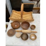 AN ASSORTMENT OF TREEN ITEMS TO INCLUDE A ROLLING PIN, BOWLS AND A TRUG BASKET ETC