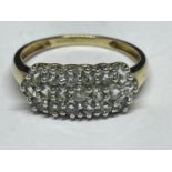 A 9 CARAT GOLD RING WITH NINETEEN CUBIC ZIRCONIAS IN A BAND DESIGN SIZE V/W