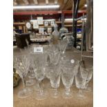 A COLLECTION OF CUT GLASS GLASSES TO INCLUDE CHAMPAGNE FLUTES, WINE, SHERRY, ETC