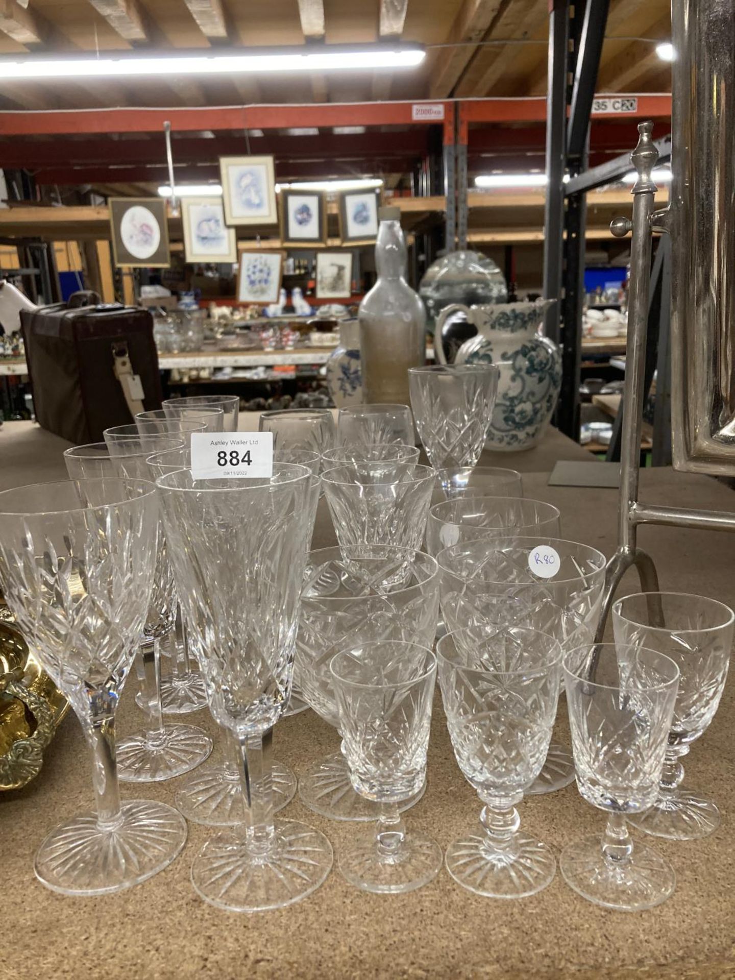 A COLLECTION OF CUT GLASS GLASSES TO INCLUDE CHAMPAGNE FLUTES, WINE, SHERRY, ETC