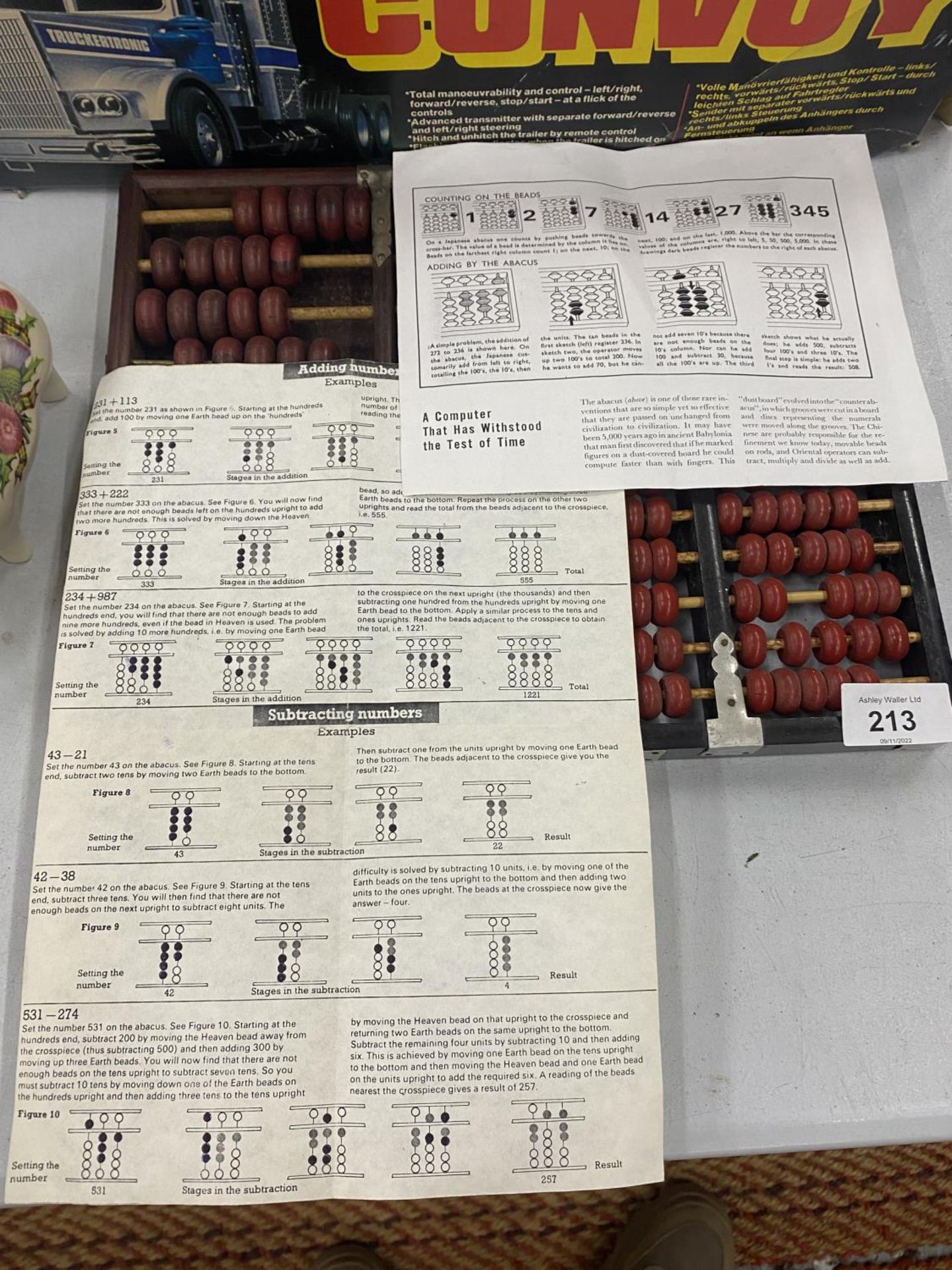 TWO JAPANESE ABACUS WITH INSTRUCTIONS AND A BOOKLET