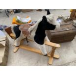 A CHILDRENS ROCKING HORSE WITH WOODEN BASE