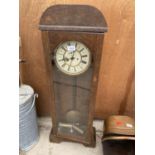 AN OAK CASED TABLE TOP EIGHT DAY CLOCK COMPLETE WITH PENDULUM, WEIGHTS AND ROMAN NUMERAL DIAL