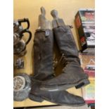 A PAIR OF VINTAGE LEATHER RIDING BOOTS WITH FRONT LACES AND WOODEN BOOT SHAPERS