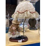 A TABLE LAMP WITH ON A WOODEN BASE WITH CERAMIC LADY'S HEAD DECORATION