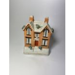 A VICTORIAN STAFFORDSHIRE POTTERY COTTAGE MONEY BOX