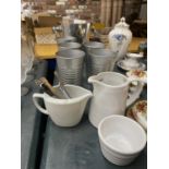 A STAINLESS STEEL ICE BUCKET, METAL TUMBLERS, WHITE JUGS, SPOONS, ETC