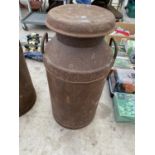 A VINTAGE METAL MILK CHURN WITH LID