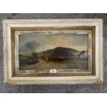 A VICTORIAN OIL ON BOARD DEPICTING A SAILING BOAT IN HIGHLAND LAKE SCENE