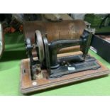 A VINTAGE HAND WIND SEWING MACHINE WITH DECORATED CASE