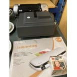 A TEXET LAMINATOR, A NOVAMAT 515F PROJECTOR, LAMINATING SHEETS, ETC