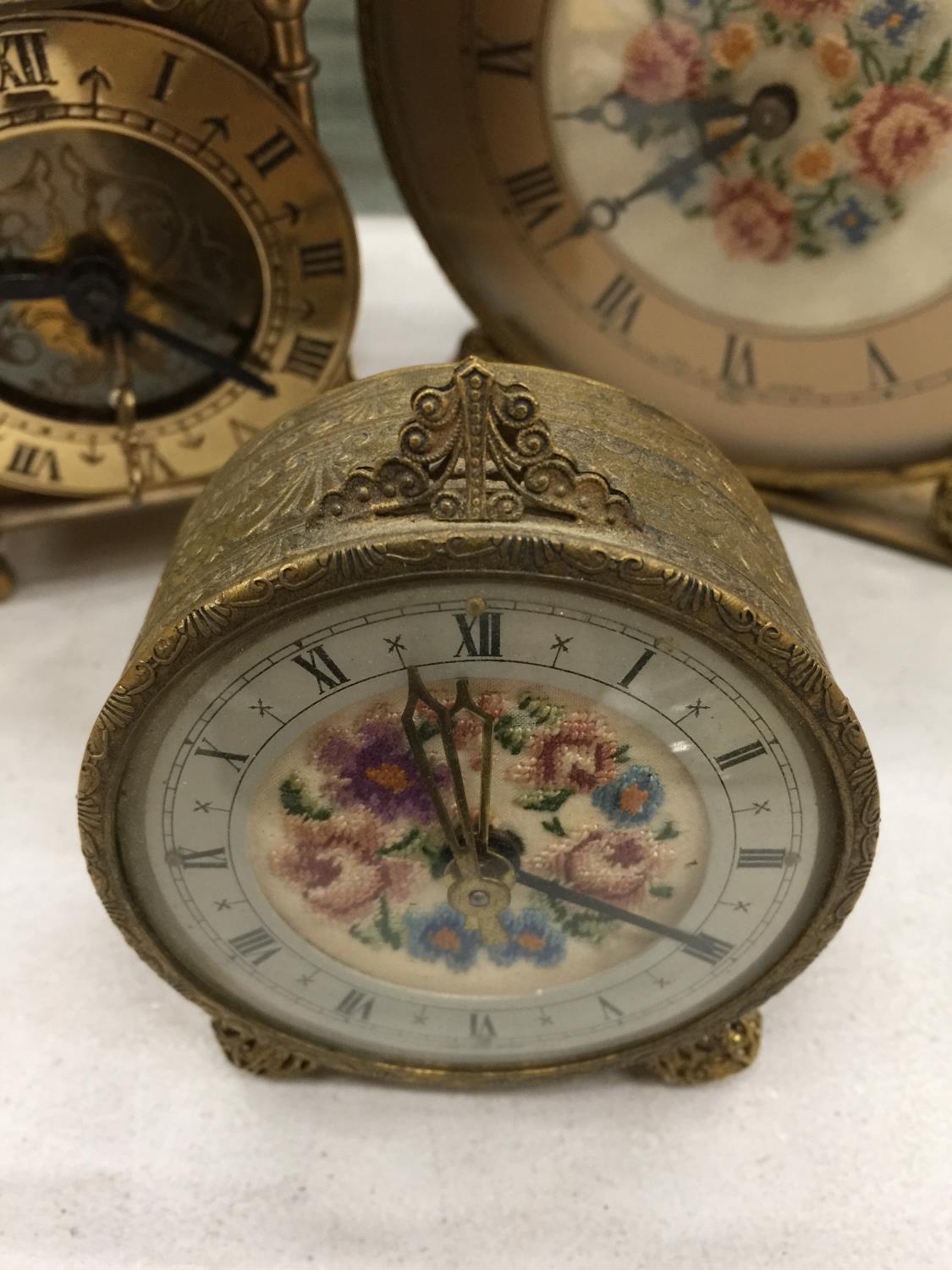 THREE VINTAGE CLOCKS TO INCLUDE A BRASS LANTERN CLOCK, A PETIT POINT MANTLE CLOCK AND ALARM CLOCK - Image 2 of 5