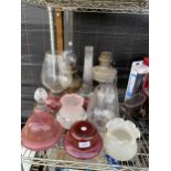 FIVE VARIOUS VINTAGE OIL LAMPS AND AN ASSORTMENT OF GLASS SHADES
