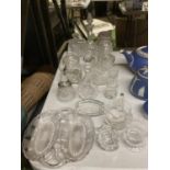 A QUANTITY OF GLASSWARE TO INCLUDE OIL/VINEGAR BOTTLES, LIDDED TRINKET POTS, A BELL, MILK JUG,