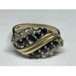 A 9 CARAT GOLD RING WITH TEN SAPPHIRES AND EIGHT CUBIC ZIRCONIAS ON A TWIST DESIGN SIZE O