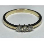A 9 CARAT GOLD RING WITH THREE IN LINE DIAMONDS SIZE T