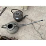 A VINTAGE GALVANISED WATERING CAN AND A HEAVY CAST IRON HOLCROFT & SONS KETTLE