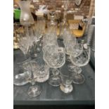 A QUANTITY OF GLASSES TO INCLUDE DECANTERS, CHAMPAGNE FLUTES, BRANDY GLASSES, WINE GLASSES, ETC