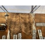 A LARGE ANIMAL HIDE RUG