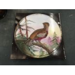 A VINTAGE CERAMIC TILE WITH AN IMAGE OF A PHEASANT