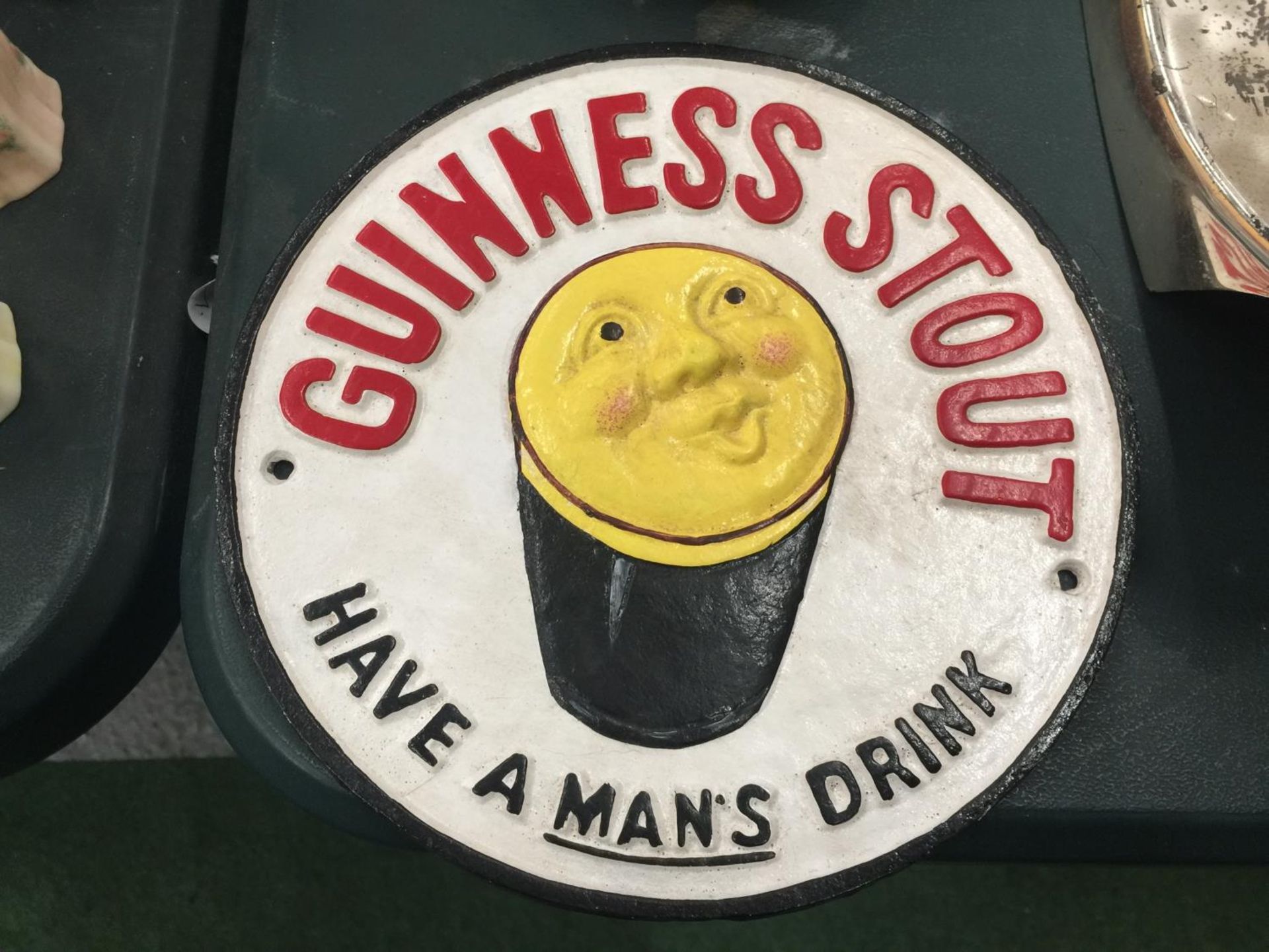 A CAST GUINNESS STOUT SIGN DIAMETER 24CM