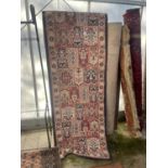 A LONG BLUE AND RED PATTERNED RUG