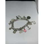 A AMRKED SILVER CHARM BRACELET WITH A HEART PADLOCK AND ELEVEN CHARMS