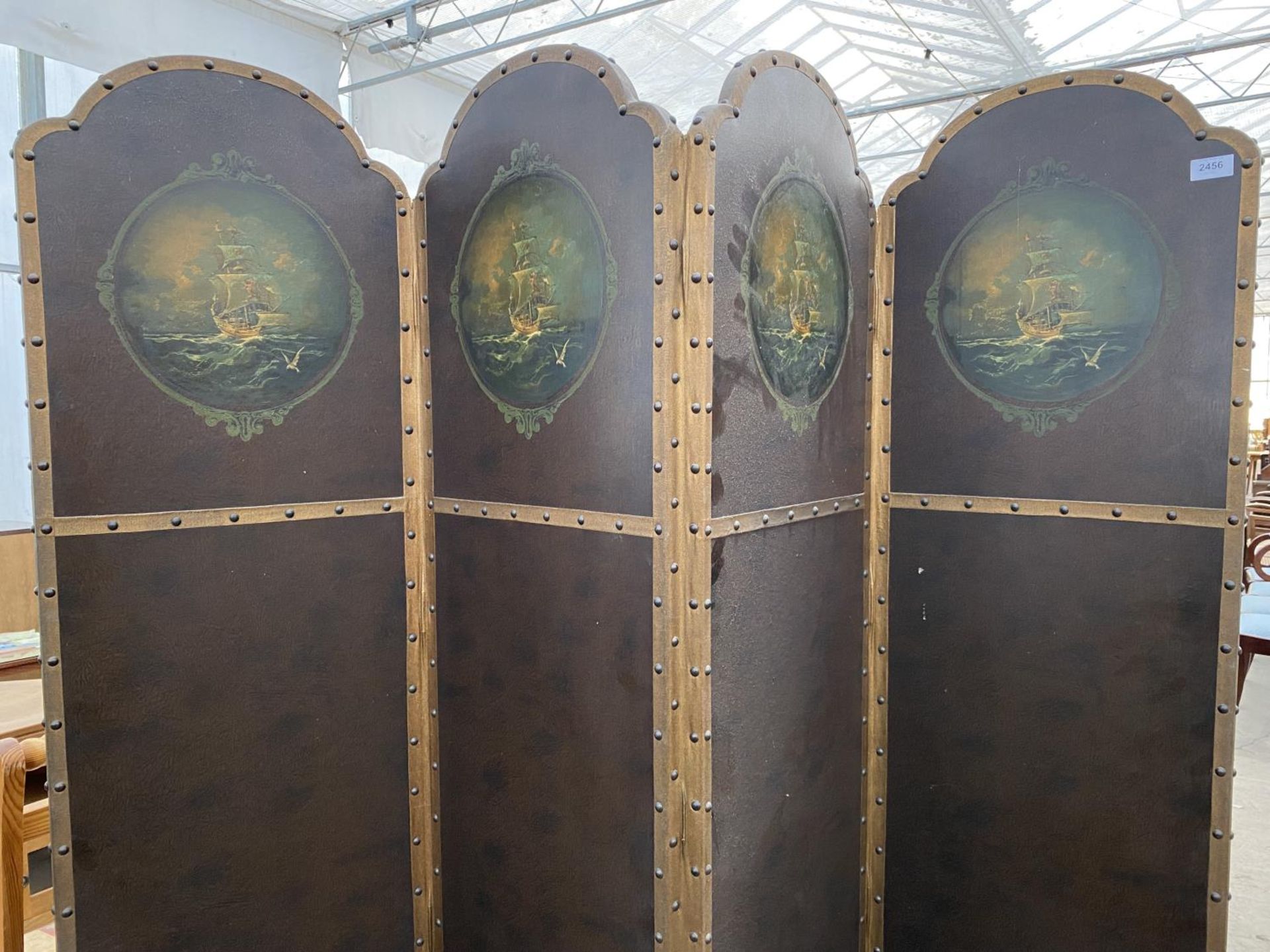 AN EDWARDIAN FOUR DIVISION STUDDED LEATHERETTE SCREEN WITH ARCHED TOPS HAVING PAINTED MASTED SHIP - Image 2 of 4