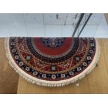 A RED PATTERNED OVAL AXMINSTER FRINGED RUG