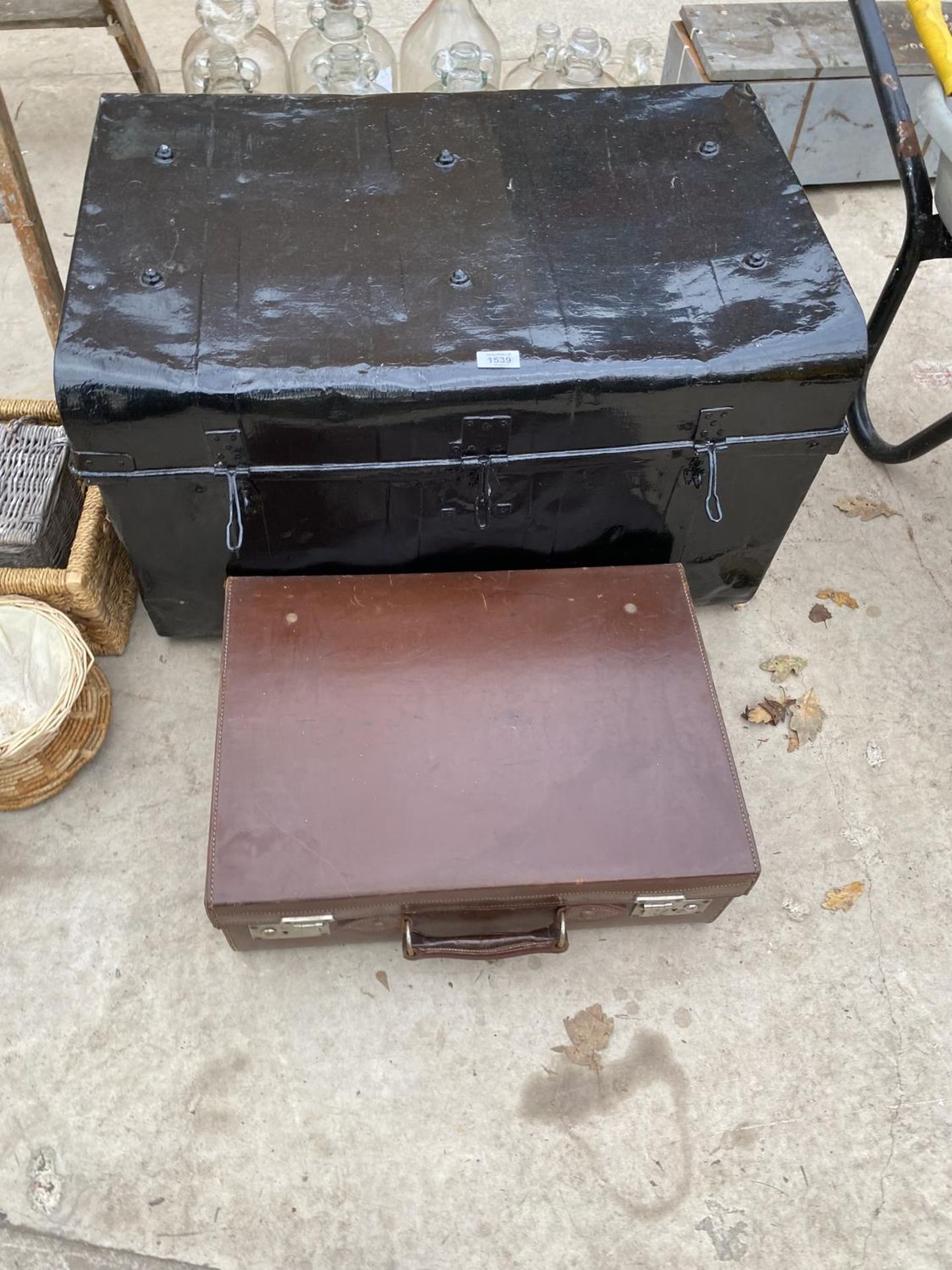 A VINTAGE METAL TRAVEL TRUNK AND A FURTHER VINTAGE LEATHER BRIEFCASE