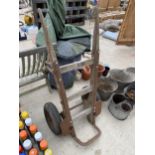 A LARGE VINTAGE WOODEN AND METAL SACK TRUCK WITH LARGE RUBBER WHEELS