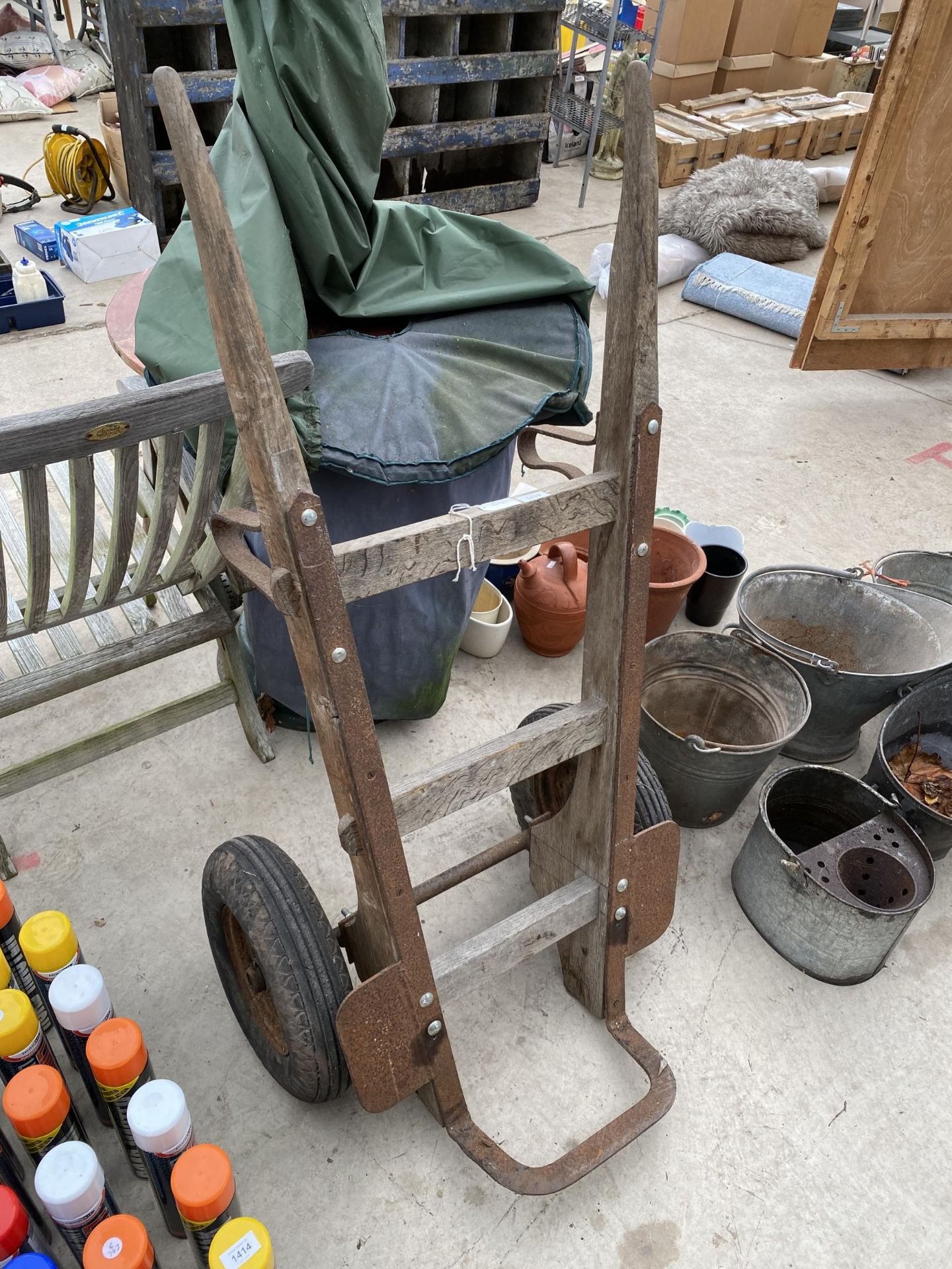 A LARGE VINTAGE WOODEN AND METAL SACK TRUCK WITH LARGE RUBBER WHEELS