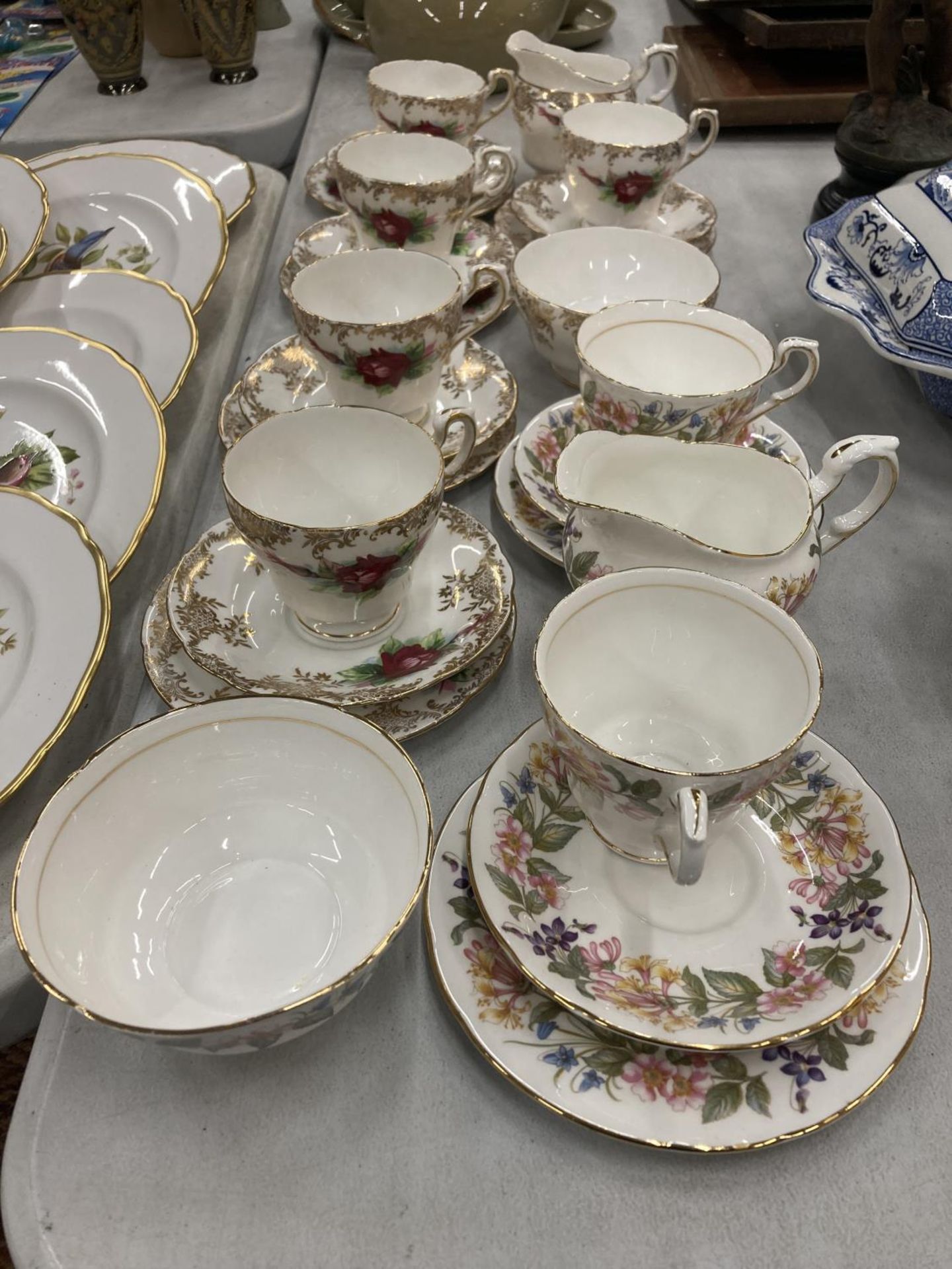 A QUANTITY PARAGON 'COUNTRY LANE' CUPS, SAUCERS AND SIDE PLATES PLUS PARAGON CUPS, SAUCERS, SIDE