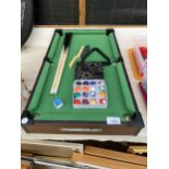 A POWER PLAY MINITURE TABLE TOP POOL TABLE WITH TWO CUES, BALLS AND TRIANGLE ETC