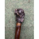 A VINTAGE WOODEN WALKING STICK WITH METAL DOG HEAD FINIAL
