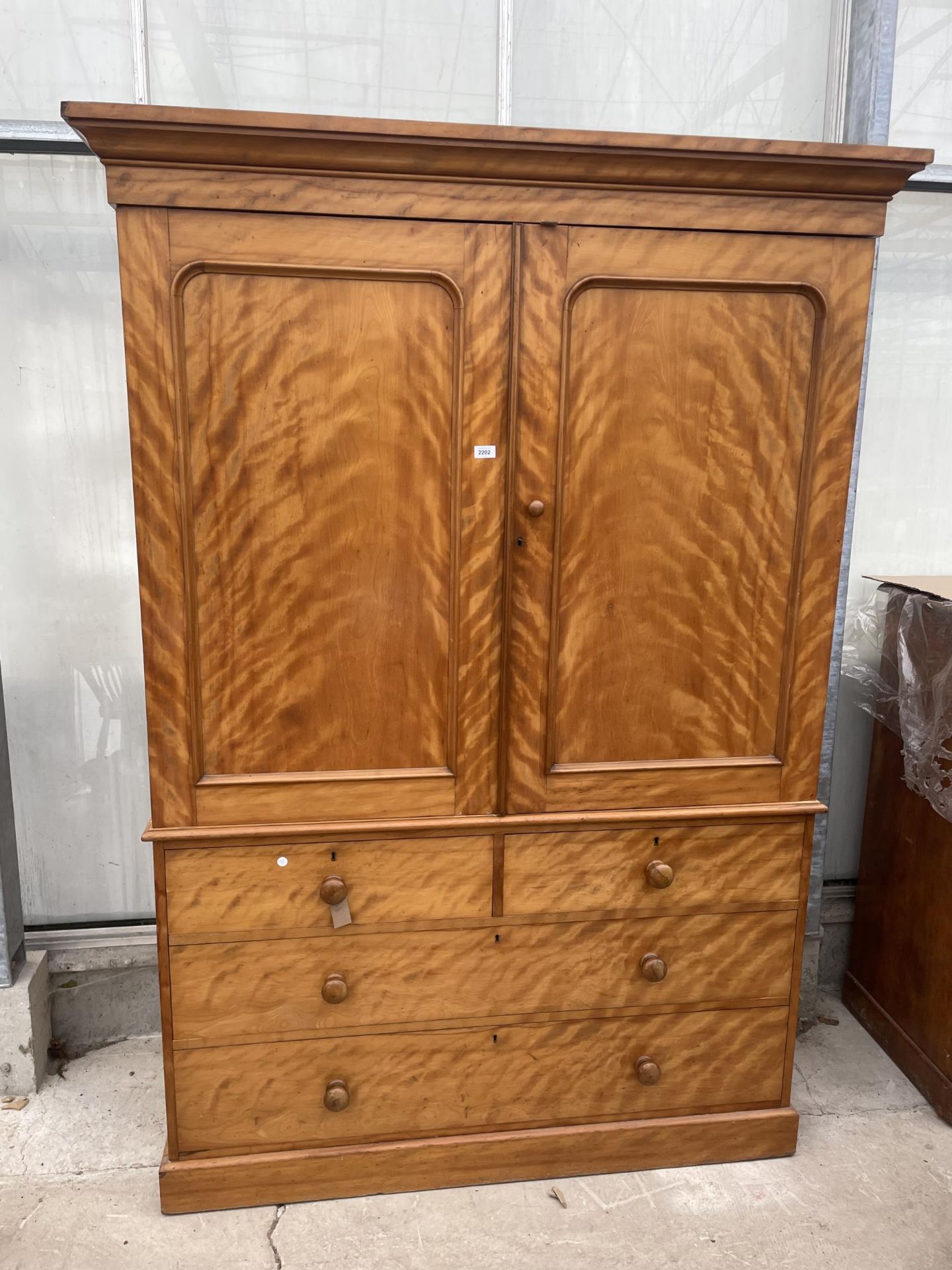 A VICTORIAN SATINWOOD HEAL & SON (LONDON) LINEN PRESS, THE TOP ENCLOSING FOUR SLIDES, THE BASE