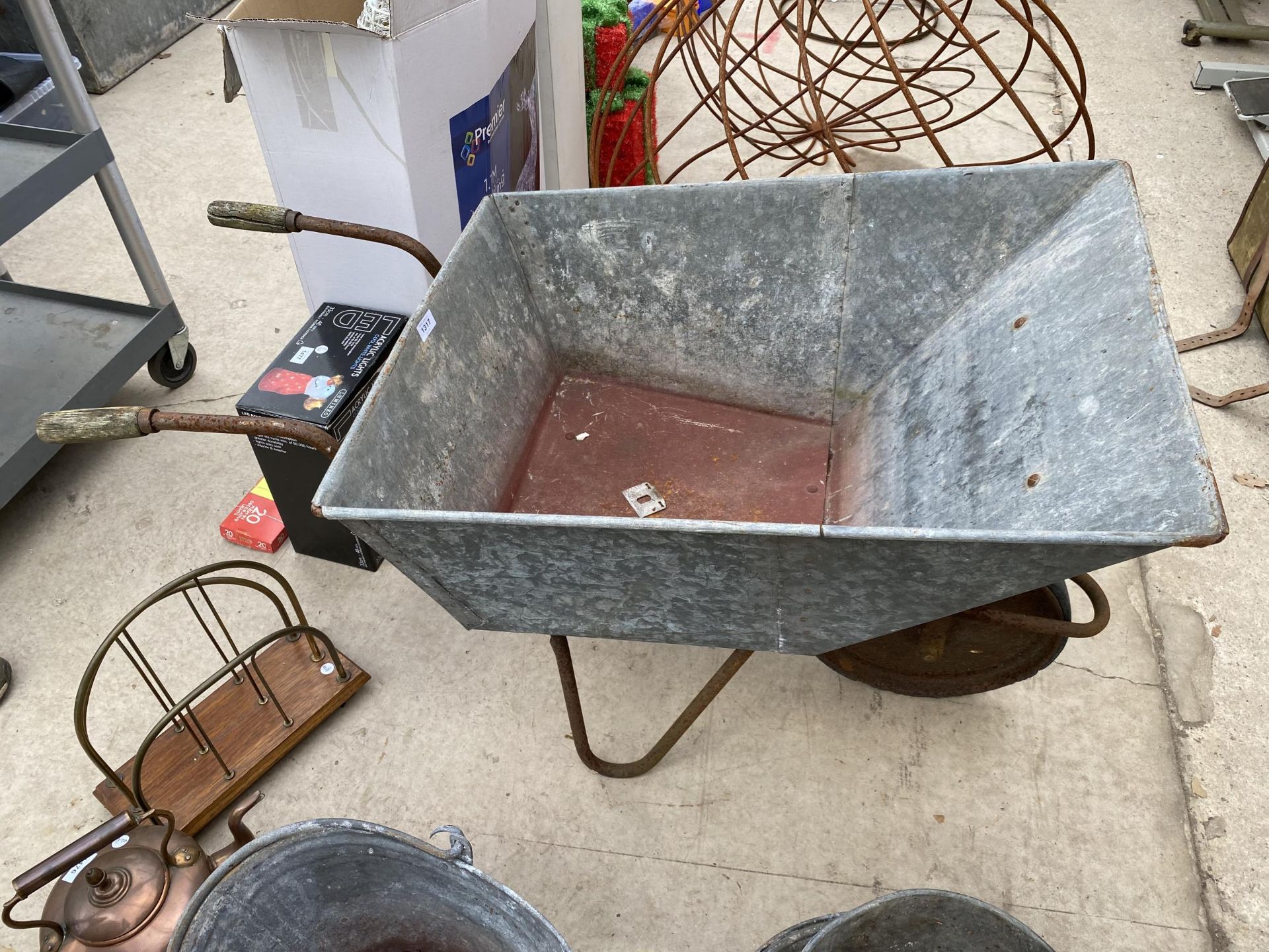 A VINTAGE GALVANISED WHEELBARROW