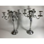 A LARGE PAIR OF CHROME FOUR BRANCH CANDLESTICKS WITH CENTRAL CIRCULAR SECTION