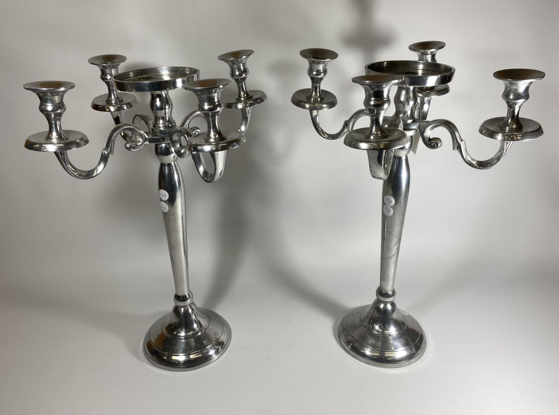 A LARGE PAIR OF CHROME FOUR BRANCH CANDLESTICKS WITH CENTRAL CIRCULAR SECTION