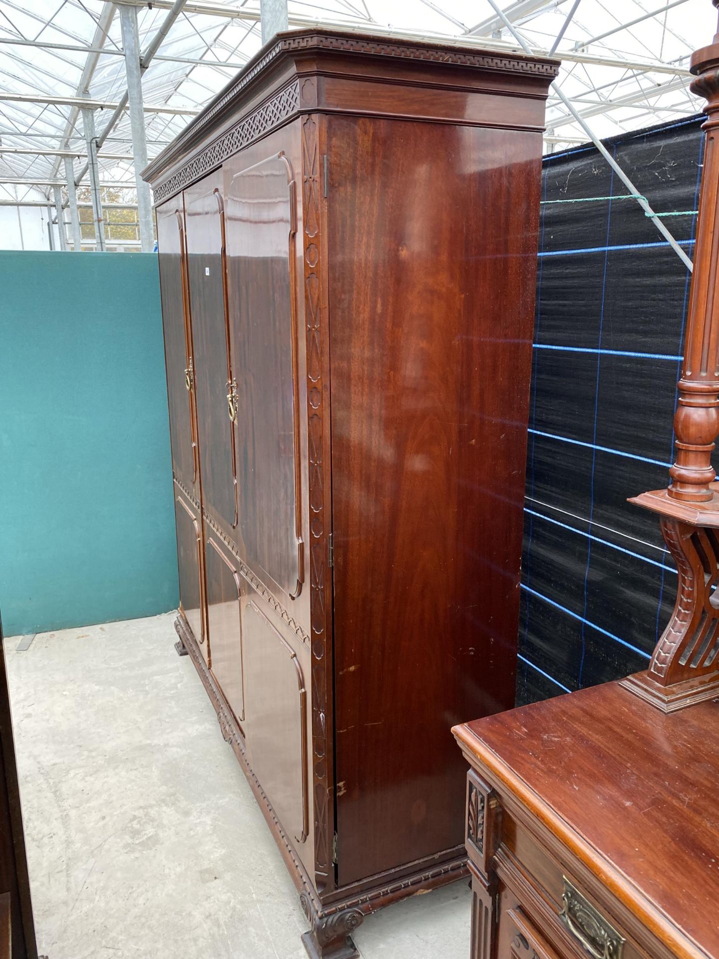 AN EDWARDIAN MAHOGANY 'CHIPPENDALE' STYLE TRIPLE WARDROBE ENCLOSING HANGING COMPARTMENTS, FIVE - Image 4 of 14