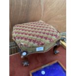 A VINTAGE MAHOGANY AND UPHOLSTERED FOOTSTOOL WITH SCROOL FEET