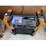 A TRITON ELECTRIC PLANER THICKNESSER COMPLETE WITH INSTRUCTION MANUAL