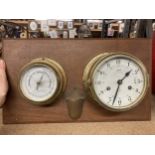 A BRASS BAROMETER AND CLOCK ON A WOODEN BASE