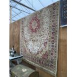 A LARGE CREAM PATTERNED FRINGED RUG BEARING THE LABEL MADE IN BELGIUM (200CM X 300CM)