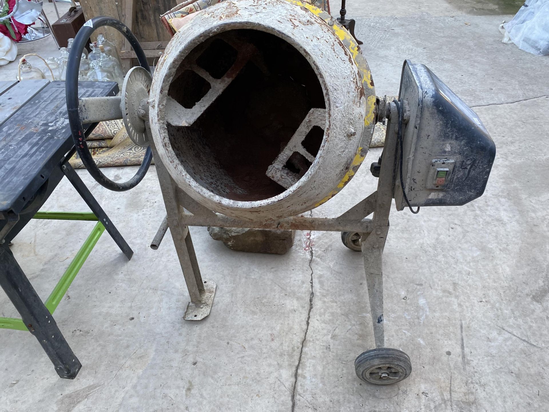 AN ELECTRIC ROLL OVER CEMENT MIXER