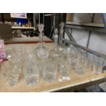 A QUANTITY OF GLASSWARE TO INCLUDE DECANTERS, TUMBLERS, BRANDY GLASSES, ETC