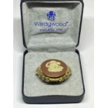 A WEDGEWOOD BROOCH IN A PRESENTATION BOX