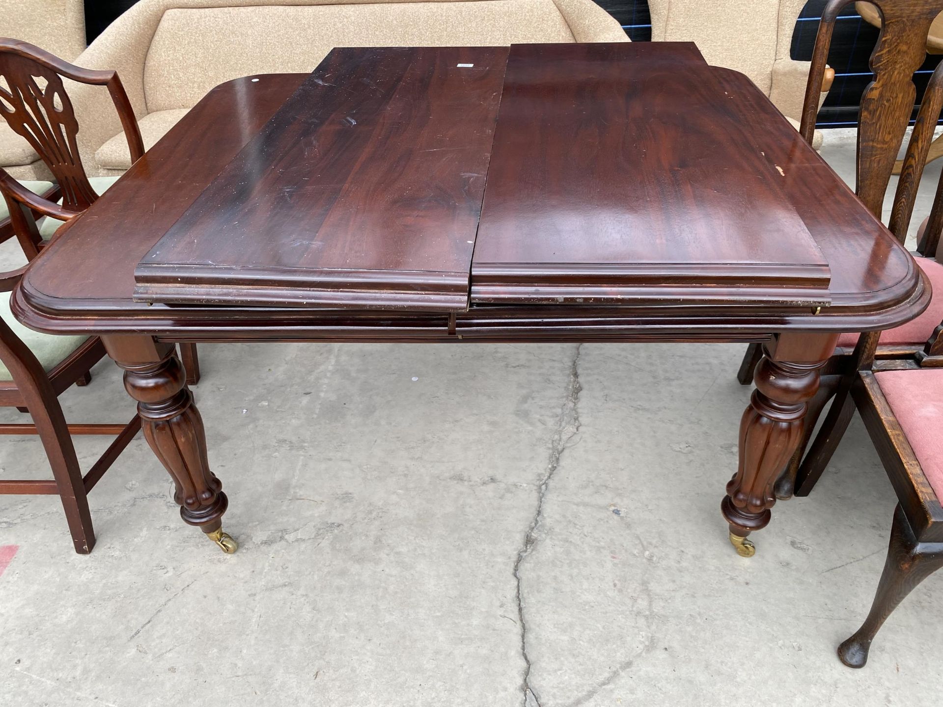 A VICTORIAN STYLE MAHOGANY PULL-OUT DINING TABLE, 59X48" (TWO LEAVES 19" EACH)
