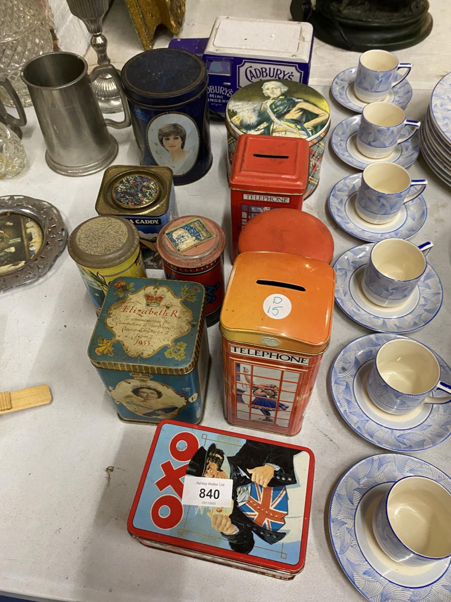 A COLLECTION OF VINTAGE TINS TO INCLUDE CHURCHILLS TELEPHONE BOX MONEY BOXES, CADBURY'S VAN,