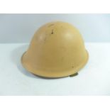A YELLOW PAINTED METAL HELMET AND LINER, DATED 1952